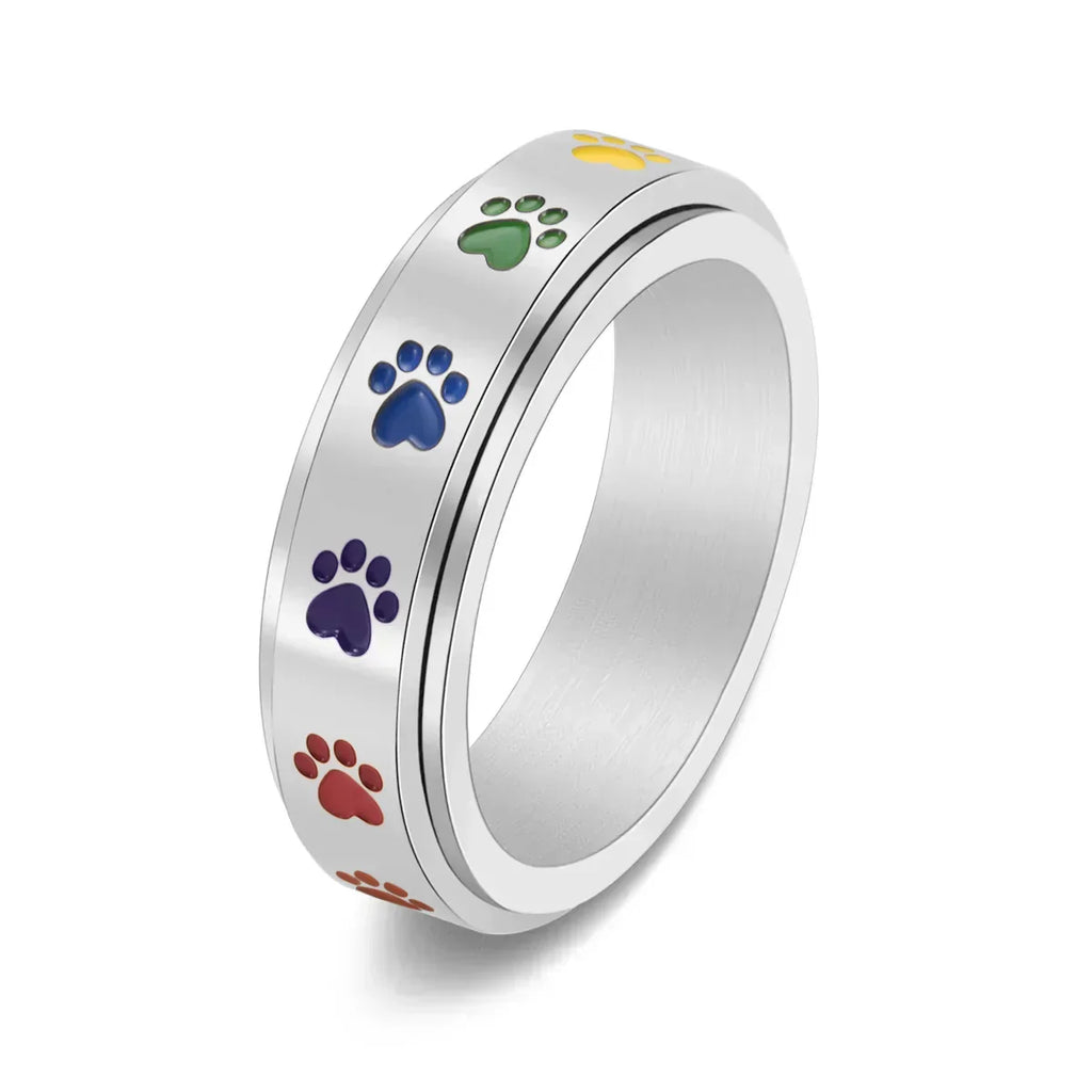 Thea - Anillo antiestrés giratorio con huellas de colores