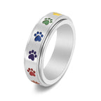 Thea - Anillo antiestrés giratorio con huellas de colores