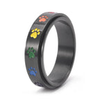 Thea - Anillo antiestrés giratorio con huellas de colores