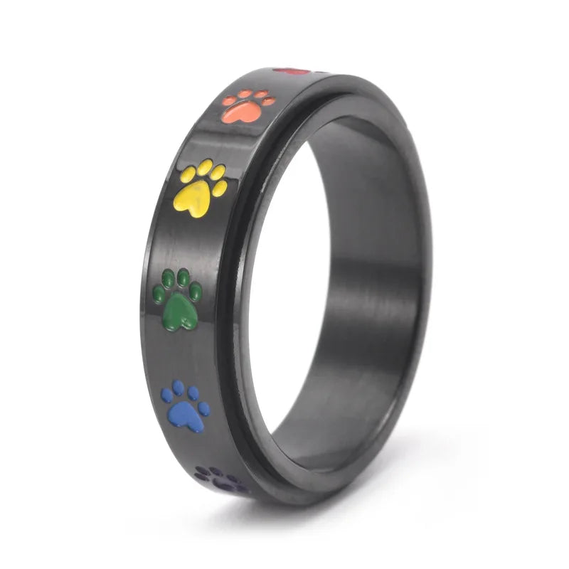 Thea - Anillo antiestrés giratorio con huellas de colores