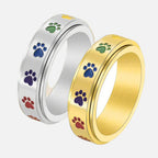 Thea - Anillo antiestrés giratorio con huellas de colores