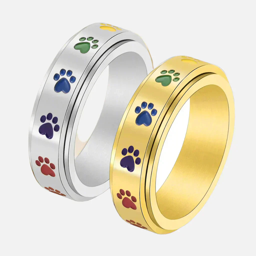 Thea - Anillo antiestrés giratorio con huellas de colores