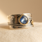 Anillo de banda ancha de plata y oro con piedra azul